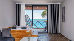 A modern living room with a view of the sea, a hanging chair, and a wooden sofa. - Adora Calma Beach Hotel - Adults Only (Manavgat)