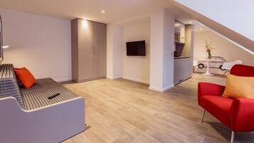 Apartment, 1 Queen Bed | Living room | 30-inch TV with cable channels