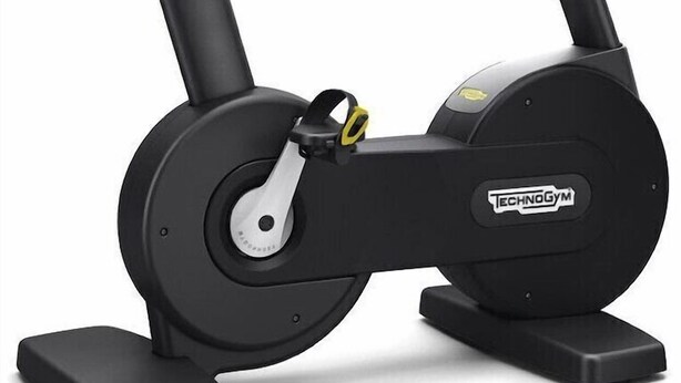 A stationary exercise bike with a digital display, adjustable seat, and a sturdy base. - Hotel Amiternum (L'Aquila)