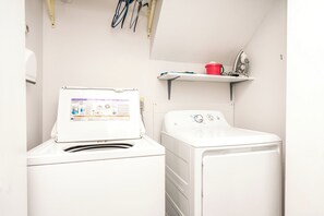 A laundry area with a front-loading washing machine and a dryer.