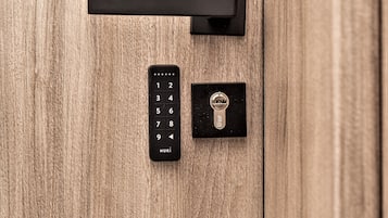 A wooden door with a black numeric keypad and a keyhole.
