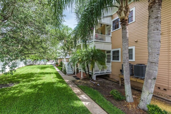 A residential building with a two-story structure, a front porch, and a well-maintained lawn. - Newly renovated, 2 bedroom, 1 bath spacious condo (St. Augustine)