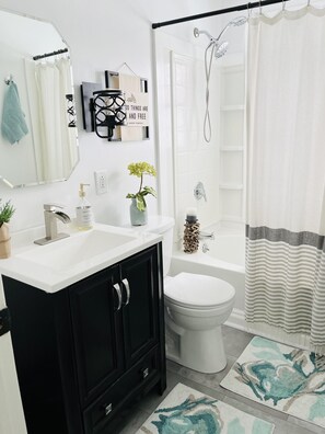 Bathtub, hair dryer, towels, soap