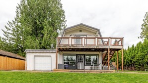 A two-story house with a covered porch and a garage.