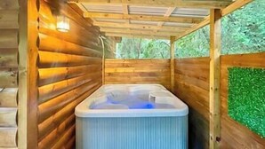 A wooden cabin with a hot tub under a wooden roof. - NEWTinycabin/Hottub/Firepit/Yard/5minParkWay (Sevier County)