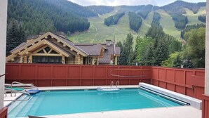 A swimming pool with a view of a mountain landscape.