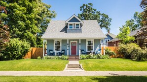 A two-story house with a front porch, a red door, and a number '508' on the front. - The Rustic Rose - 4 Bedroom House w/ HOT TUB near Downtown (Walla Walla)
