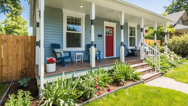 A house with a covered porch, a red door, and a number '5' on the front. - The Rustic Rose - 4 Bedroom House w/ HOT TUB near Downtown (Walla Walla)