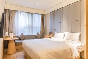 A hotel room with a large bed, a bedside table, a nightstand, a window with curtains, and a wall with a panel design. - Ji Hotel Shanghai The Bund Town City God Templ (Shanghai)