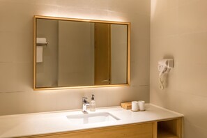 A bathroom with a large mirror, a sink, a hand dryer, and a soap dispenser. - Ji Hotel Shanghai The Bund Town City God Templ (Shanghai)