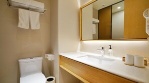 A modern bathroom with a toilet, sink, mirror, and towel rack. - Ji Hotel Shanghai The Bund Town City God Templ (Shanghai)