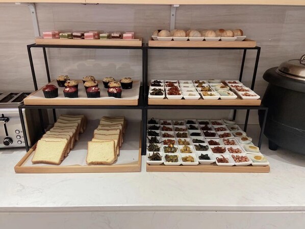A bakery display with various baked goods and pastries. - Ji Hotel Shanghai The Bund Town City God Templ (Shanghai)