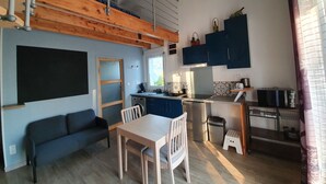A compact living space with a kitchenette, a dining area, and a sofa. - Duplex Nights & Days in Nuits-Saint-Georges (Nuits-Saint-Georges)