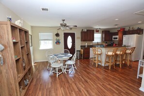 Enjoy meals in the well-equipped kitchen and dining area with a round table and comfortable seating.