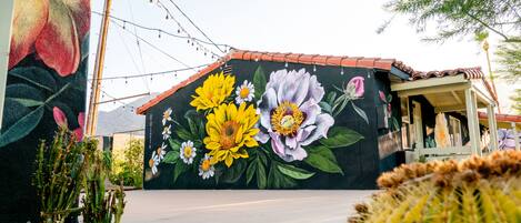 A building with a mural of flowers and cacti.