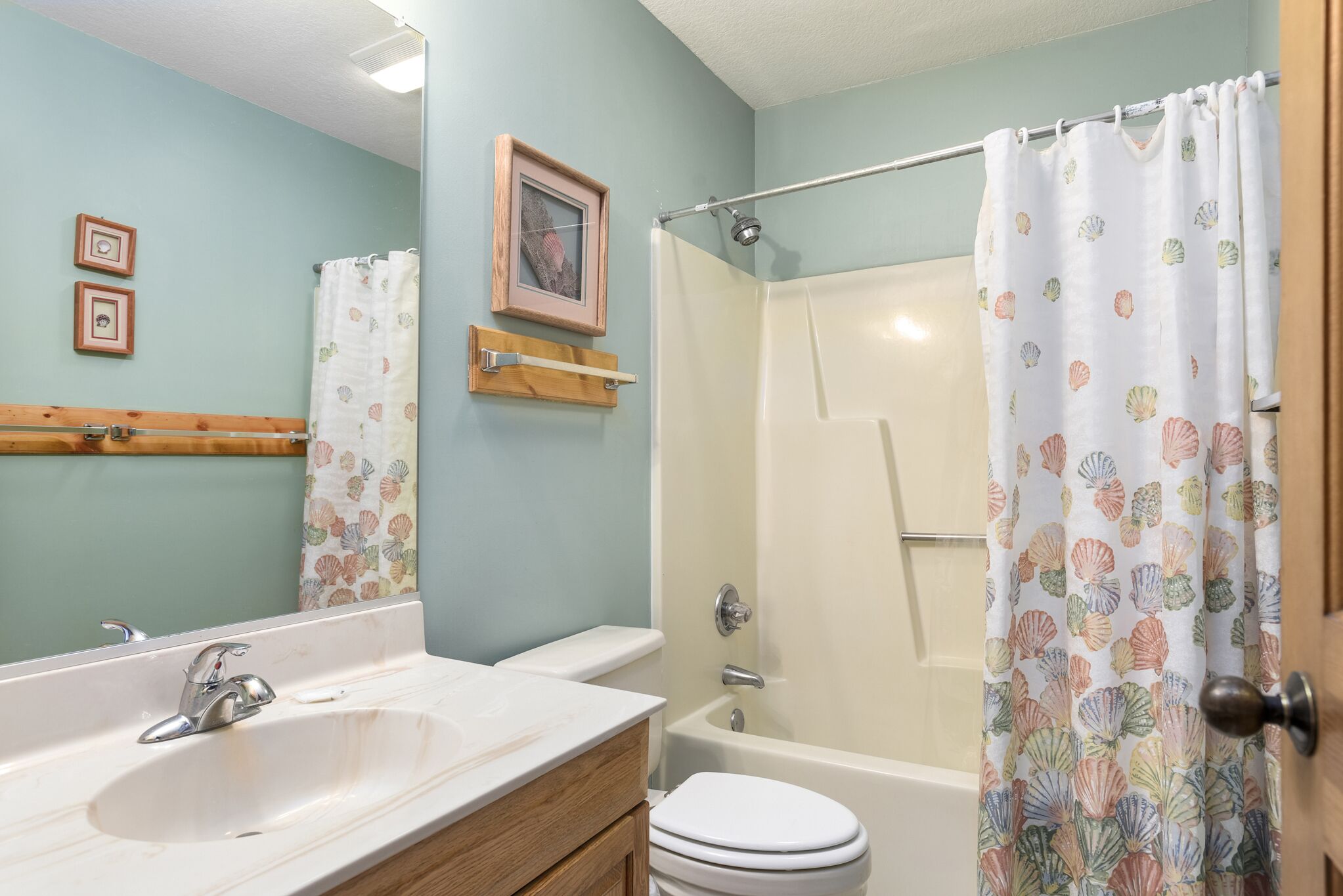 A bathroom with a sink, toilet, and bathtub.
