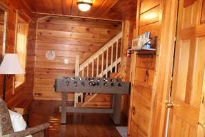 A wooden interior with a foosball table, a staircase, and a lamp. - Great Mountain Views, Family Friendly, Hot tub, 5 miles to Downtown Blue Ridge (Blue Ridge)