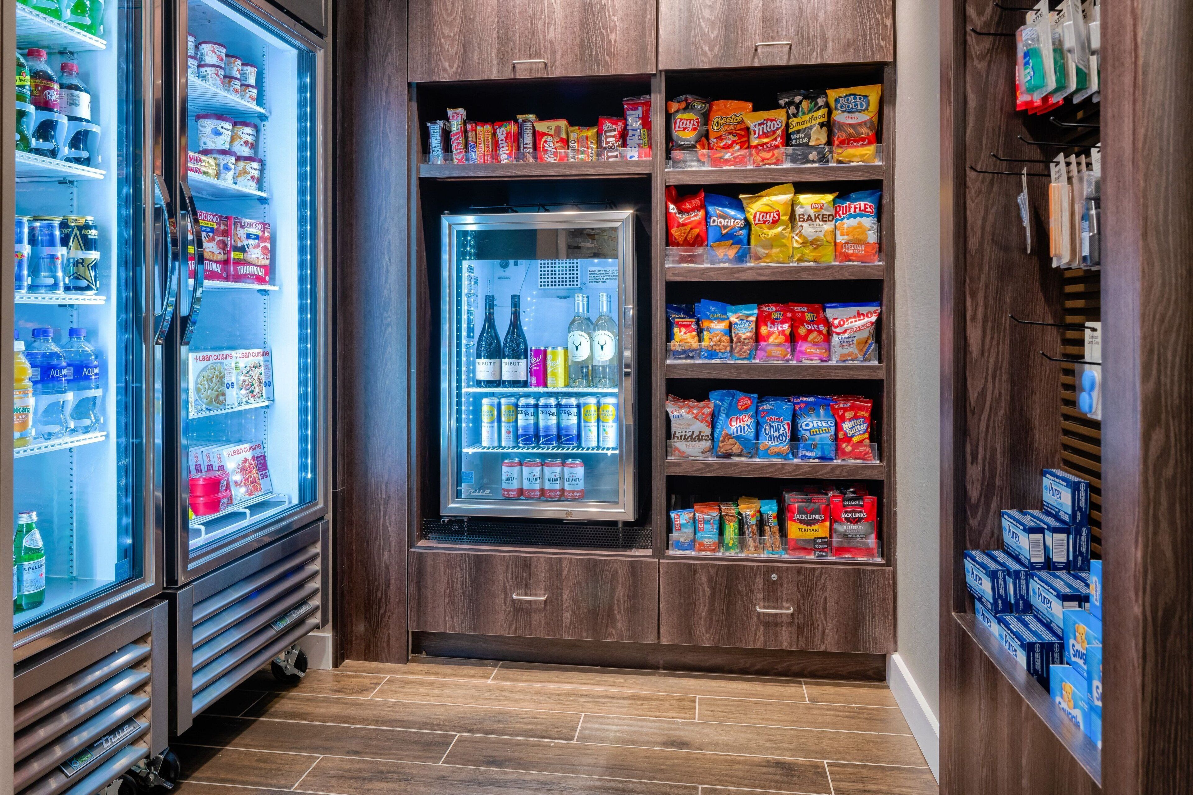 A self-service beverage station with a variety of drinks and snacks.