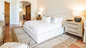 A bedroom with a bed, bedside tables, a ceiling fan, and a rug. - Peaceful Palmilla Ocean View Oasis Steps to Beach (Palmilla)