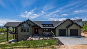 Enjoy a spacious front porch with a seating area and covered patio, perfect for relaxing in the landscaped yard.