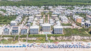 A coastal residential area with beachfront properties, a beach with umbrellas, and a dense cluster of houses. - 30A Beach House - Stillwater Cottage By Panhandle Getaways (Panama City Beach)
