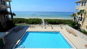 A swimming pool with lounge chairs and a view of the beach. - 30A Beach House - Stillwater Cottage By Panhandle Getaways (Panama City Beach)