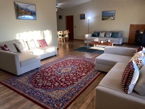 A living room with two sofas, a coffee table, and a patterned rug.