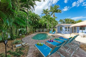 A heated pool, sun loungers