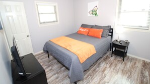A bedroom with a bed, a nightstand, a TV, and a ceiling fan. - Remodeled Broken Arrow Home -Dogs OK -Safe Location -Fully Privacy Fenced Yard  (Broken Arrow)