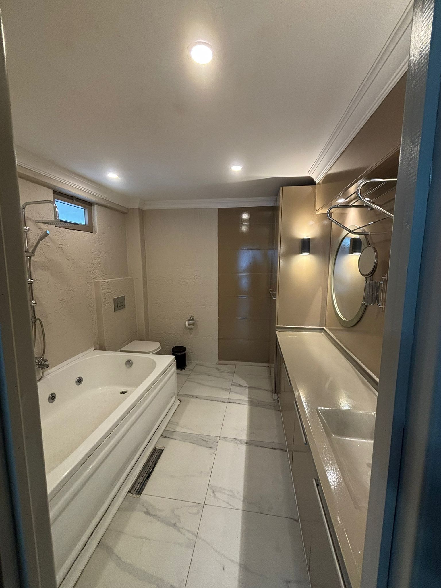 A bathroom with a bathtub, toilet, and sink.
