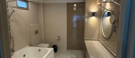 A bathroom with a bathtub, toilet, and sink.