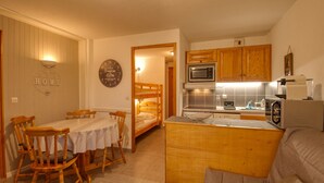 A compact living space with a dining area, a kitchenette, and a sleeping area. - Renovated apartment near lake and shuttle, 4 pers, non-smoking, no internet (Morillon Village)