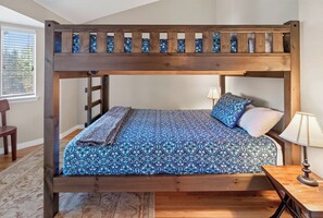 A bunk bed with a wooden frame and a blue patterned bedspread. - Nice Updated Condo. Hot Tub. Access to Lake. (Frisco)