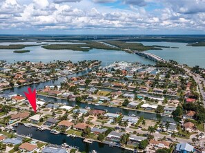 An aerial view of a coastal residential area with houses, a marina, and a bridge. - Waterfront 3BR/2BA Marco Island home with heated pool and Wi-Fi. (Marco Island)