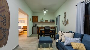 A compact living space with a dining area, kitchenette, and a sofa with cushions. - 🌿🌿 Tamarind 4 (Durango)