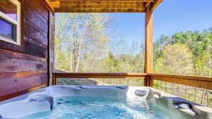 A wooden cabin with a hot tub on a deck. - Sunshine Ridge, Hot Tub, Game Room, $560 FREE tickets each paid day (Sevierville)