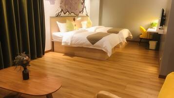 A modern hotel room with a large bed, a desk, and a chair.