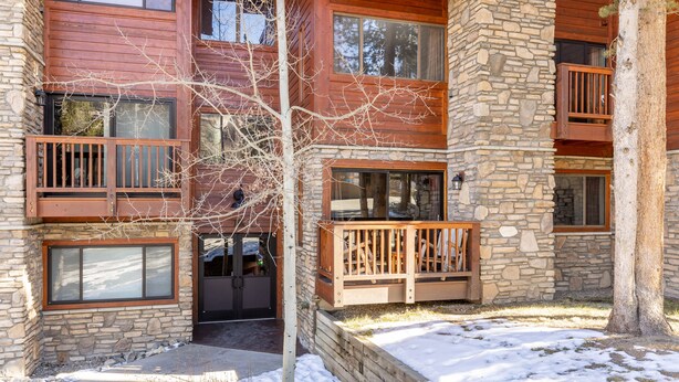 A multi-story building with stone and wood exterior, balconies, and large windows. - Breckenridge Condo Only a Short Walk to Lifts & Shops w/ 2 Private Balconies! (Breckenridge)