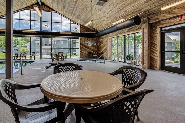 Enjoy meals and gatherings in this well-lit space with a large round table and comfortable seating for four.