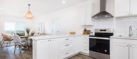 Fridge, dishwasher, coffee/tea maker, cookware/dishes/utensils