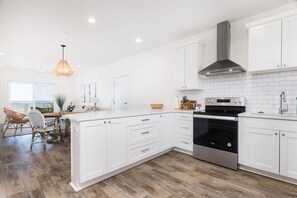 Fridge, dishwasher, coffee/tea maker, cookware/dishes/utensils