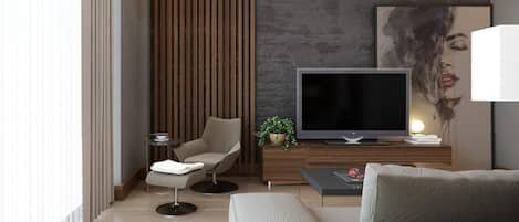 A modern living room with a flat-screen TV, a sofa, a chair, a coffee table, and a plant.