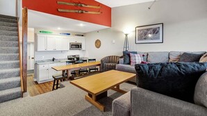 A compact living space with a kitchen, dining area, and a sofa.