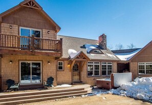A two-story wooden house with a balcony, large windows, and a covered outdoor area. - Timberline Lodge at Sunday River (Newry)