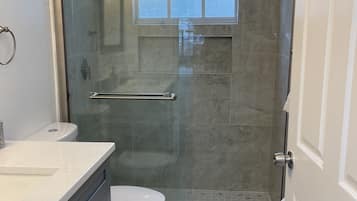 Shower, hair dryer, towels, toilet paper