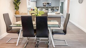 A modern kitchen with grey cabinets, a stainless steel oven, and a microwave. - Fabulous Apartment near Disney (Kissimmee)