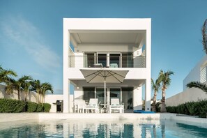 A modern two-story house with a swimming pool in front. - SulMare at Taylor Bay Luxury Villas (Providenciales)