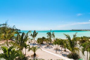 On the beach, white sand, beach umbrellas - SulMare at Taylor Bay Luxury Villas (Providenciales)