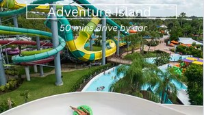 A water park with multiple slides and pools, surrounded by greenery. - MODERN/Mins to Beach/walk to dwtn/Free parking (Tarpon Springs)