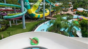 A water park with multiple slides and pools, surrounded by greenery. - MODERN/Mins to Beach/walk to dwtn/Free parking (Tarpon Springs)
